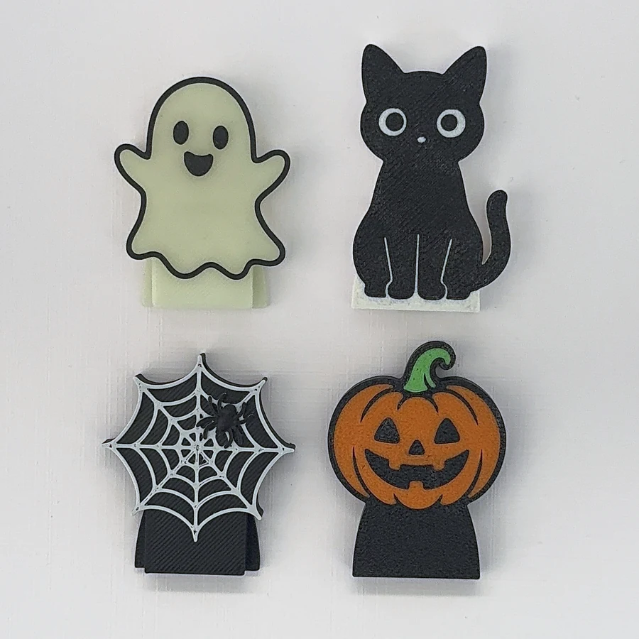 Les quatre BuddyCan de la collection Halloween : fantôme phosphorescent, chat noir, toile d’araignée et citrouille